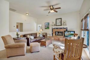 a living room with a couch and a tv at Villa Escondida in La Quinta