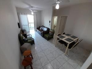 an aerial view of a living room with a table and chairs at Lindo Apto Orla da Praia do Forte Cabo-Frio RJ in Cabo Frio