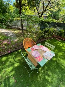 a table and chair in a yard with a table at Cozy Green Apartment Tardini, Parma in Parma