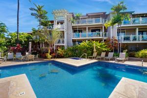 a swimming pool in front of a building at Wailea Grand Champions 7 in Wailea