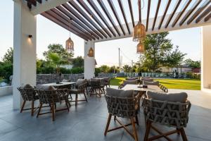 a restaurant with tables and chairs and a patio at Haven Luxury Living in Chaïdeftón