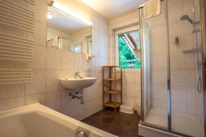 a bathroom with a tub and a sink and a shower at Appartements MaLo by we rent in Viehhofen +66 photos
