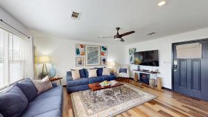 a living room with a blue couch and a table at The Lotus in Hot Springs