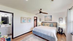 a bedroom with a bed and a ceiling fan at The Lotus in Hot Springs