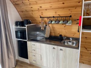 a kitchen with a sink and a counter top at 3 Hazelwood lakeside hideaway in Baston