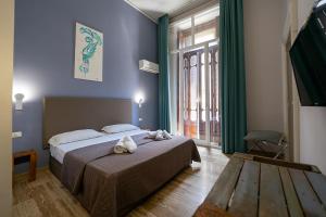 Кровать или кровати в номере GreRos Boutique H Angioino, by ClaPa Group Dislocate Hospitality