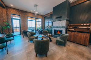 a lobby with a fireplace and tables and chairs at The Green Park Sapanca in Sapanca