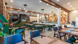 a dining room with tables and chairs at The Green Park Sapanca in Sapanca