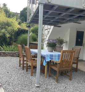 a table and chairs under an umbrella on a patio at Ferienwohnung-Eichheck in Simmerath