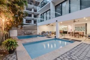 an indoor swimming pool in the middle of a house at Vela's Condos Ocean Front in Puerto Morelos