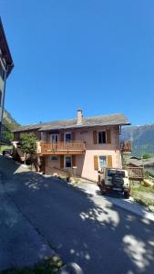 a truck parked in front of a house at Gramimmo - Appartement La Cascade in Salvan