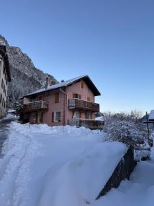 a house with a lot of snow in front of it at Gramimmo - Appartement La Cascade in Salvan