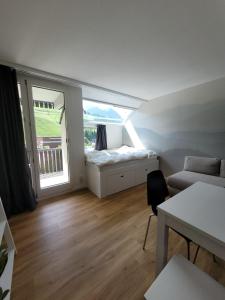 a small living room with a bed and a window at Residenza Tga Clo Apartment 111 in Savognin