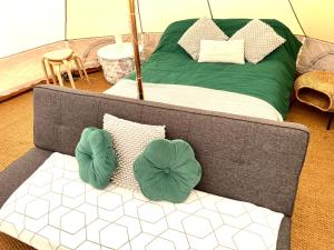 a couch with pillows on it in a room at Carrowmena School House & Glamping in Limavady +31 photos