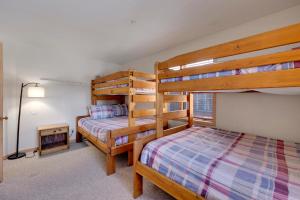 a bedroom with two bunk beds and a desk at Tyra Stream 234 by Ski Country Resorts in Breckenridge