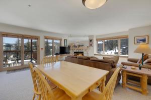 a living room with a table and a couch at Tyra Stream 234 by Ski Country Resorts in Breckenridge