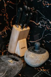 a group of knives sitting next to a knife block at Umah Bali Kuno Villa New in Tampaksiring