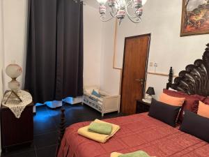 a bedroom with a bed and a crib in it at Beautiful 3-Bed House in Tavira In the city center in Tavira