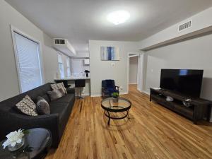 a living room with a couch and a flat screen tv at Room for rent in apartment Hartford, CT in Hartford