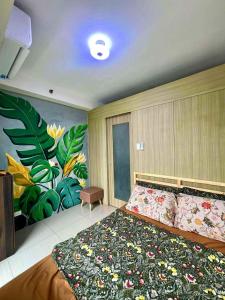 a bedroom with a large bed with a flower mural at SLY Staycation at Shore Residences Mall of Asia in Manila