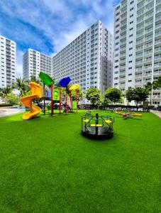 a playground in a park with a large building at SLY Staycation at Shore Residences Mall of Asia in Manila +52 photos