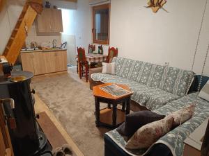 a living room with a couch and a table at Positive energy in Visoko