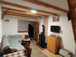 a living room with a couch and a tv at Positive energy in Visoko