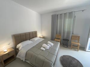 a bedroom with a bed with two towels on it at Hotel Familja Çuni Theth in Theth +72 photos
