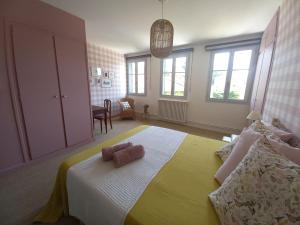 a bedroom with a bed with a yellow blanket at La Tour Bleue in Chânes +27 photos
