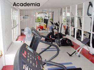 a gym with cardio equipment in a room at Gramado Village Apartamento no Centro in Gramado