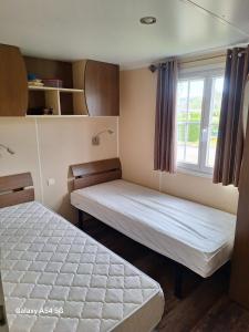 Ένα ή περισσότερα κρεβάτια σε δωμάτιο στο Mobil home