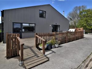 a house with a wooden fence in front of it at 3 Bed in Blandford Forum 49993 in Milton Abbas