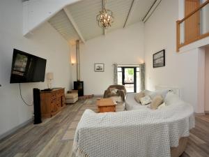 a living room with a couch and a tv at 3 Bed in Blandford Forum 49993 in Milton Abbas