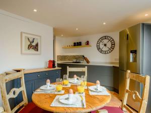 a kitchen and dining room with a wooden table at 1 Bed in Burnham Market 88221 in Burnham Market