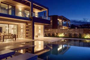 a house with a swimming pool at night at Villa Julieta 2 by Villa Plus in Tragaki +12 photos