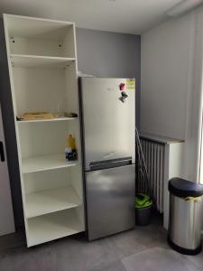 a refrigerator with its door open in a kitchen at T4 coeur de ville, à deux pas de la plage - 3 chambres in Saint-Nazaire