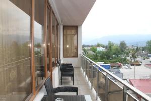 a balcony with chairs and a view of a city at Hotel 725 in Batumi