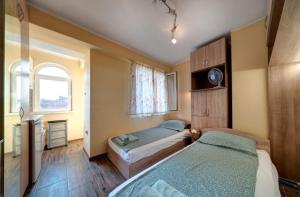 a bedroom with two beds and a window at Funny-Gunny Room to The Sea Garden in Burgas City