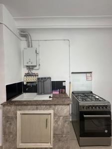 a kitchen with a stove and a counter top at appartement F2 a 2 pas de la mer in 'Aïn el Turk