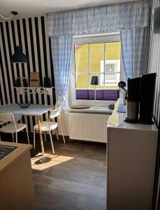 a small kitchen with a table and a window at Einbecker Auszeit in Einbeck +3 photos