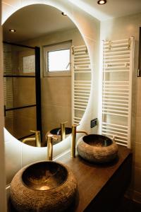 two sinks in a bathroom with a large mirror at Veluwse Wellness Lodge Selina in Ermelo