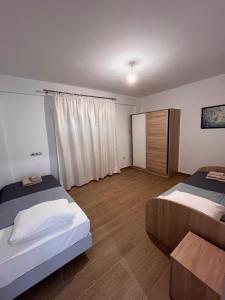 a bedroom with two beds and a table in it at Apartment In Nea Fokea in Nea Fokea