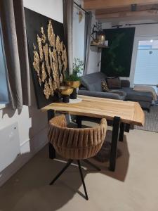a table and a chair in a living room at Villa Gloria Spielberg in Spielberg