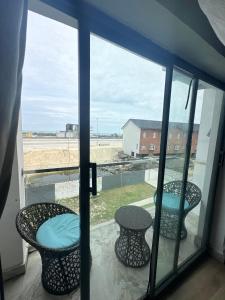 a room with a window with two chairs and a table at 2bedroom luxury apartment in Lekki