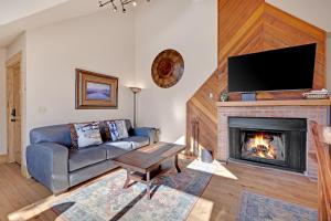a living room with a couch and a fireplace at Ski Country Penthouse 4 by Ski Country Resorts in Breckenridge
