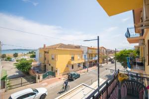 a view from a balcony of a street with buildings at La Caletta 3 in La Caletta