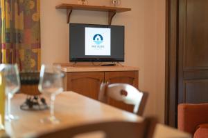 a television sitting on top of a wooden table at La Caletta 3 in La Caletta