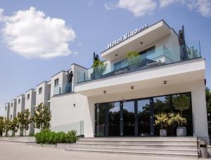a large white building with plants on the roof at Hotel Vigo in Eforie Nord