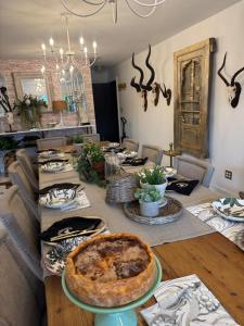 a dining room with a table with a pie on it at J and M on Capital Boutique Guesthouse in Frankfort +31 photos