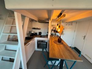 a small kitchen with a wooden table in a room at Cosy Rooftop Studio Nice Centre in Nice